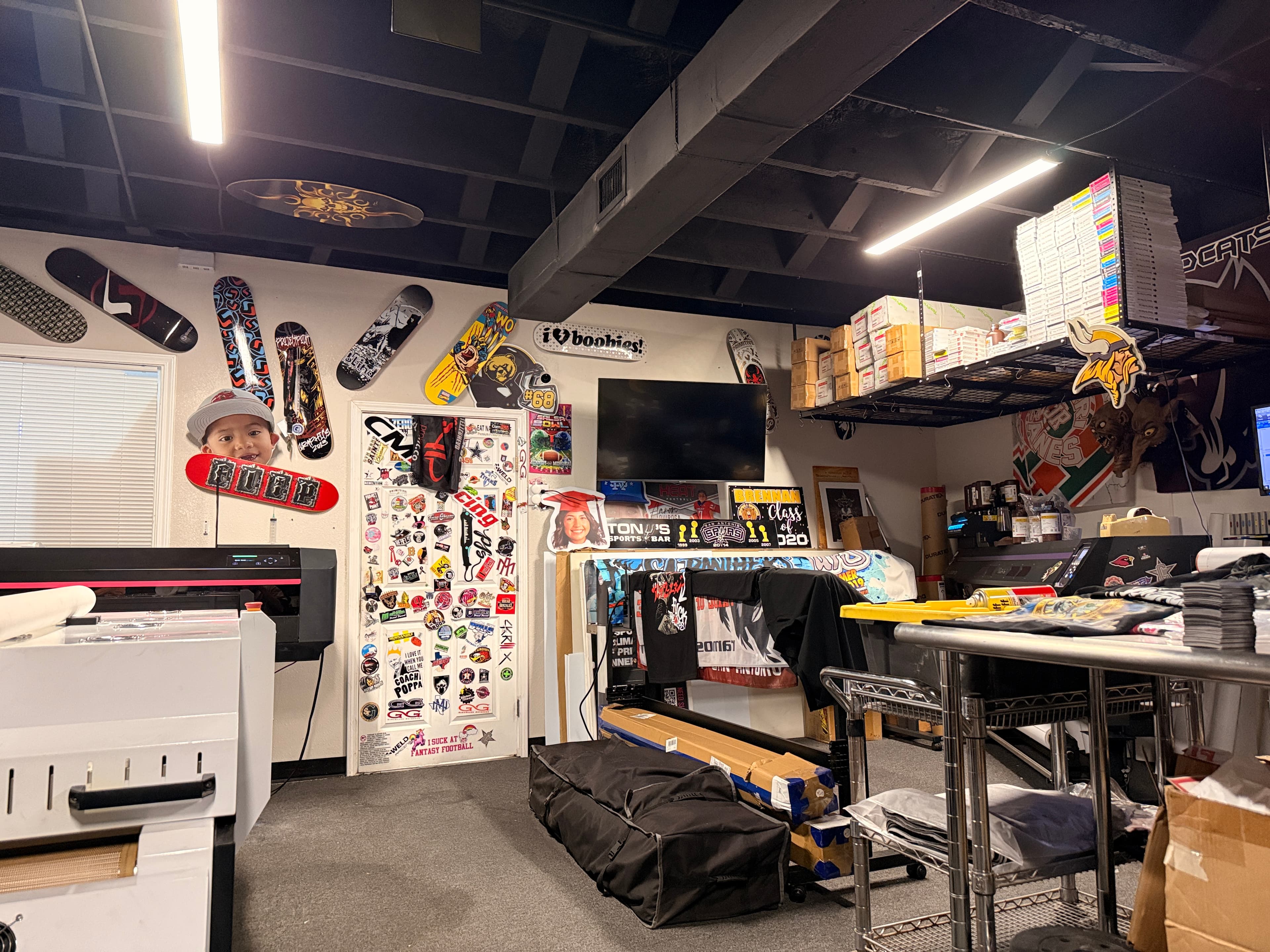 ProjectPoint office interior - custom printing shop in San Antonio with DTF printers and sticker-covered walls